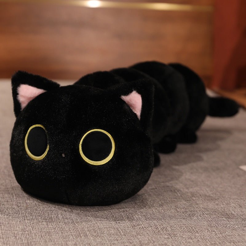 a black long cat plushie of a cat in caterpillar shape
