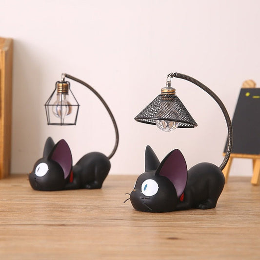 Cute black cat night lamp with a metal lamp cover on a wooden table.