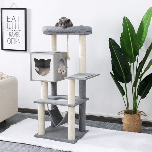 cats sleeping on a multi level cat tree with hammock