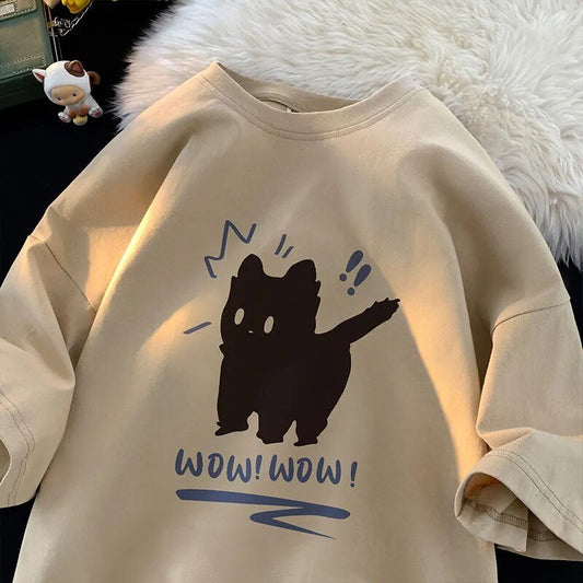 Apricot-colored t-shirt displaying a funny, shocked black cat graphic with "Wow! Wow!" caption