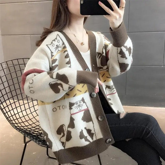 a woman taking picture while wearing womens cat sweatshirt