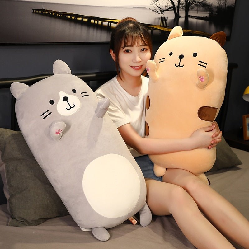 a lady hugging jumbo cat plush with different colors