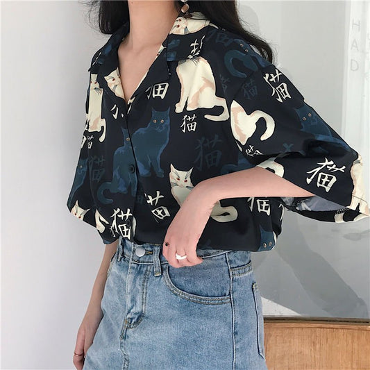 Side view of the silky navy cat blouse showing its relaxed and breathable fit.