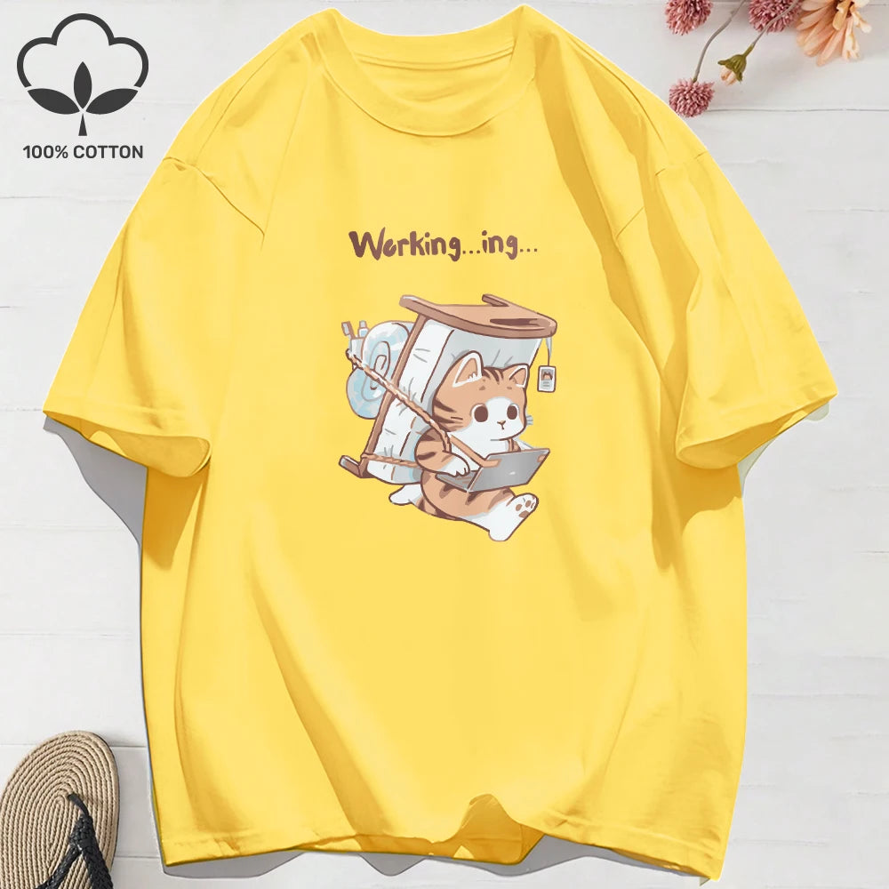 Yellow cat cartoon t-shirt featuring a ginger cat working on a laptop and carrying a bed