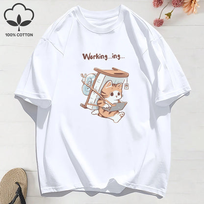 White t-shirt with a cartoon cat design and text 'Working...ing...'