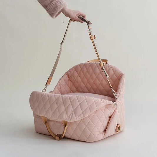 Luxury cat carrier with a practical strap  in minimalist cloudy pink color with modern quilting design