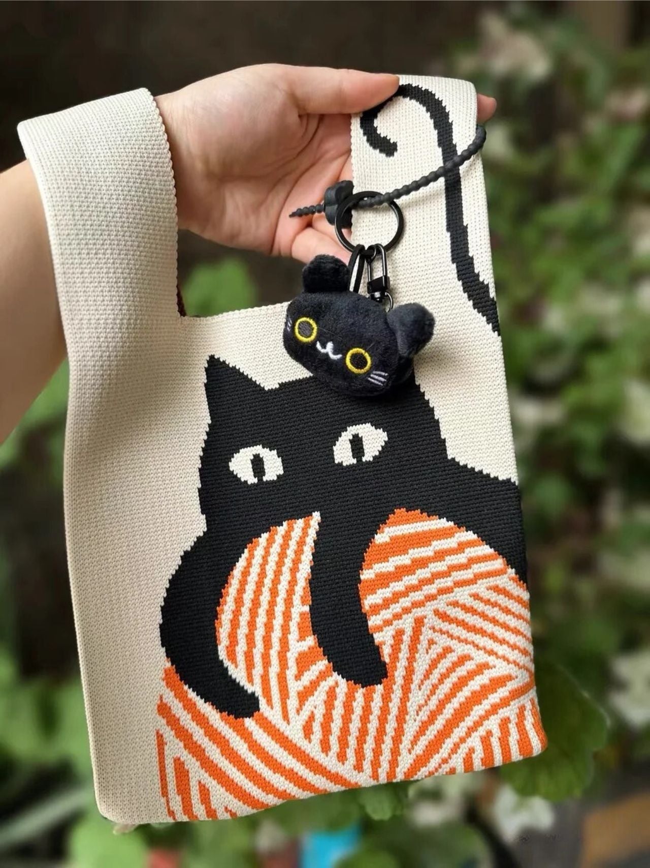 Japanese-Style Knitted Cat Wrist Bag' Being Worn on Wrist – Casual Outing