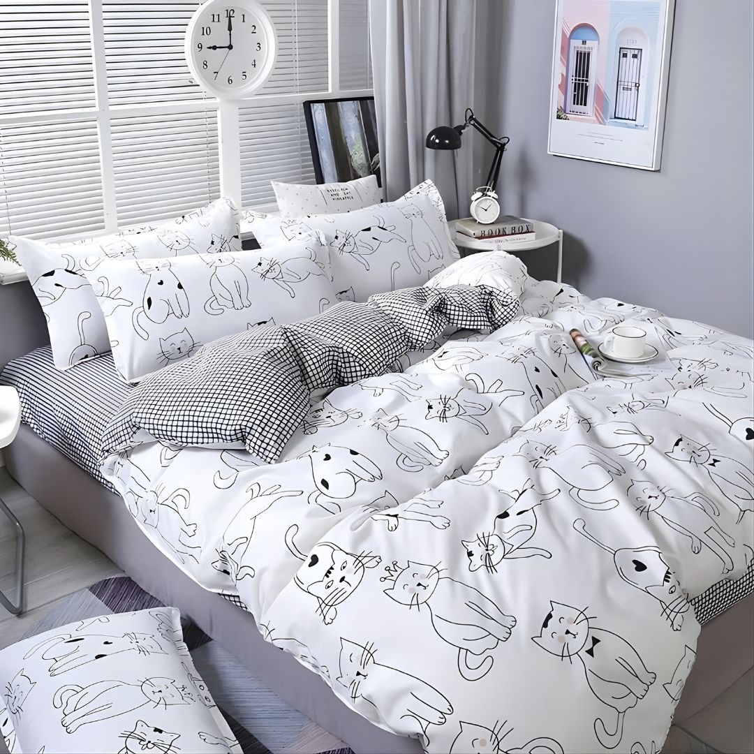 Bedroom with a bed featuring minimalist cat-themed bedding with many cat prints with bow tie
