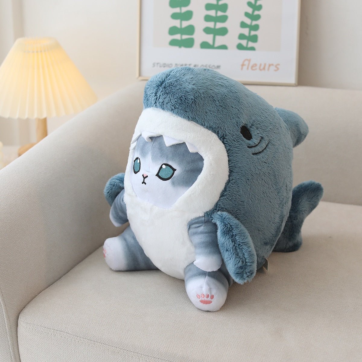 Adorable baby cat in shark costume plush