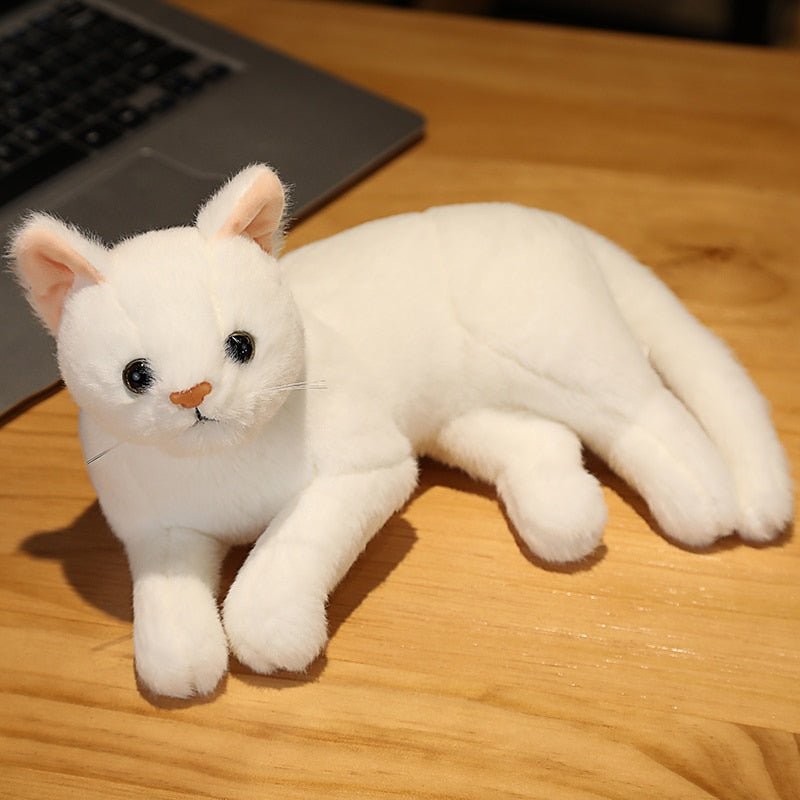 a stuffed white cat that looks realistic