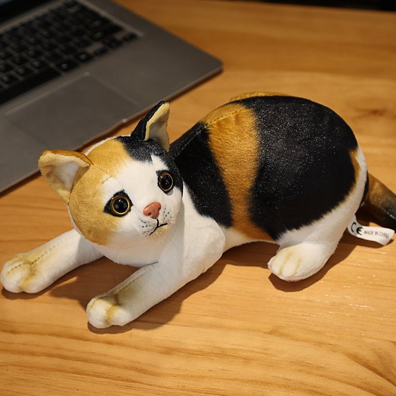 a calico cat plush that looks realistic