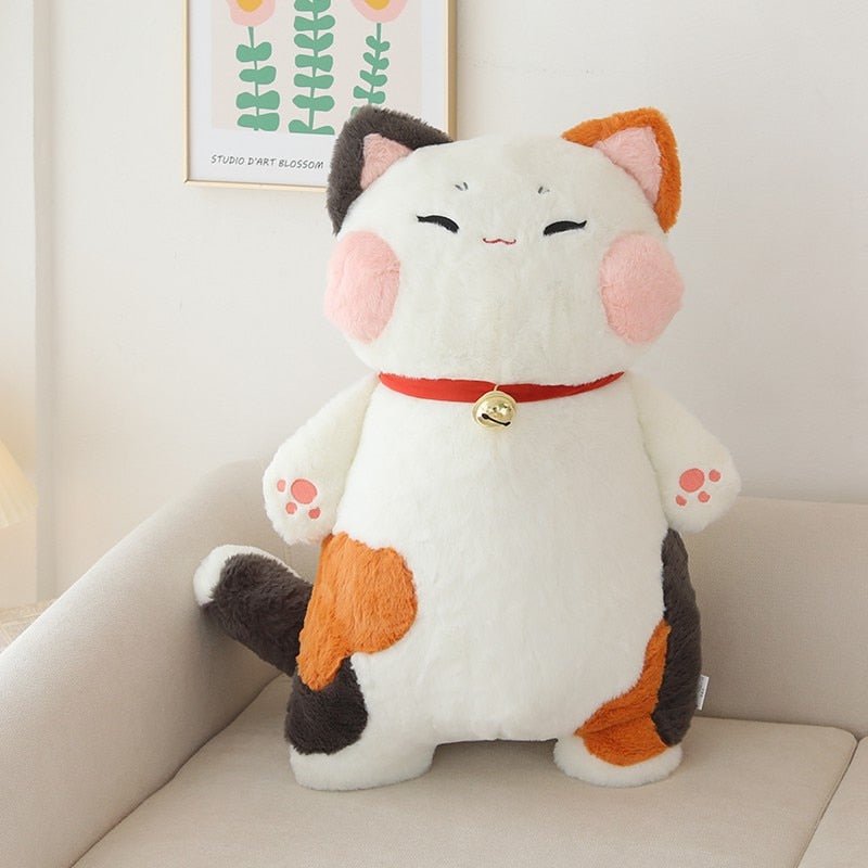a giant cat plush of a calico breed cat