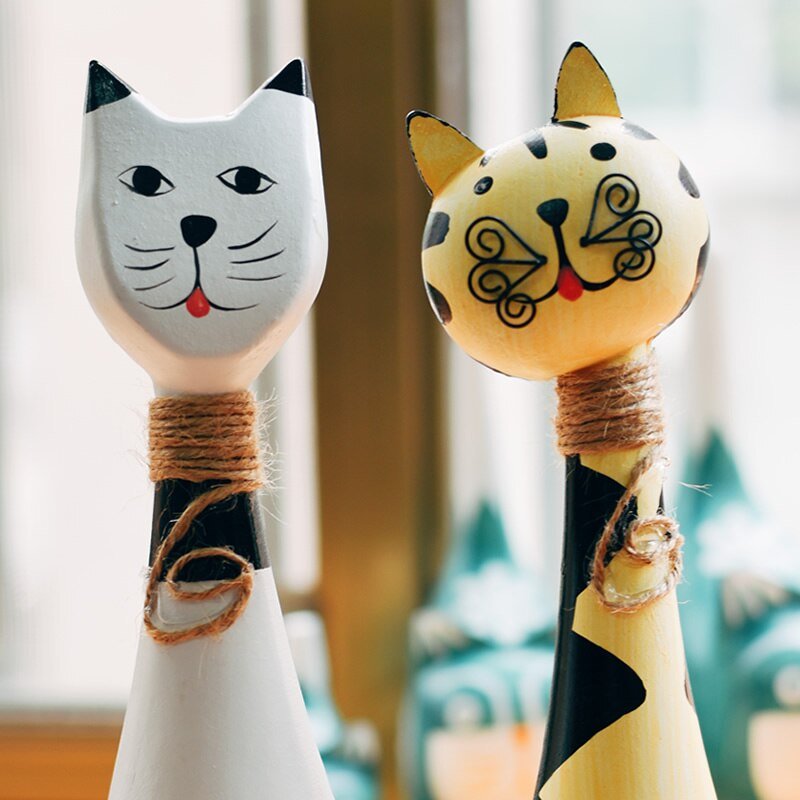 a cute white and orange cat statue with spiral whiskers for home decor