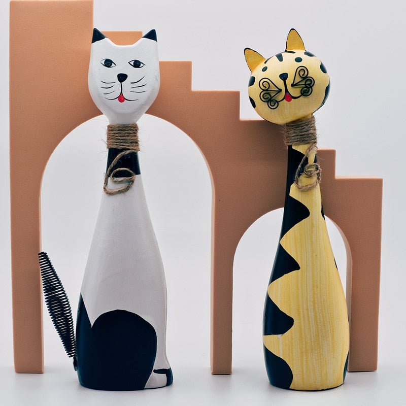 a pair of funny looking wooden cat sculptures for artistic home decor