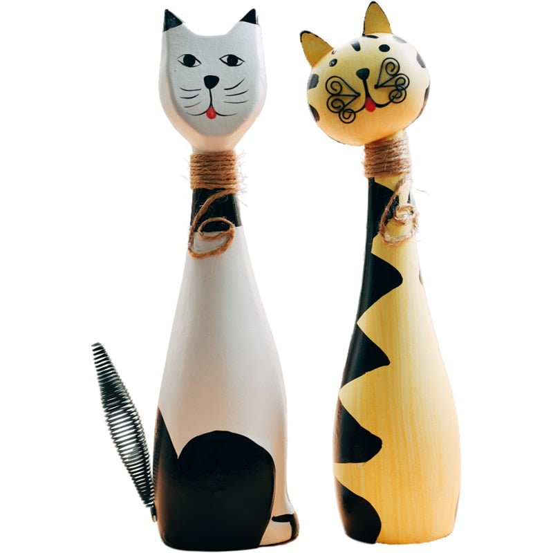 a pair of cat sculptures with funny looking faces for indoor home decor