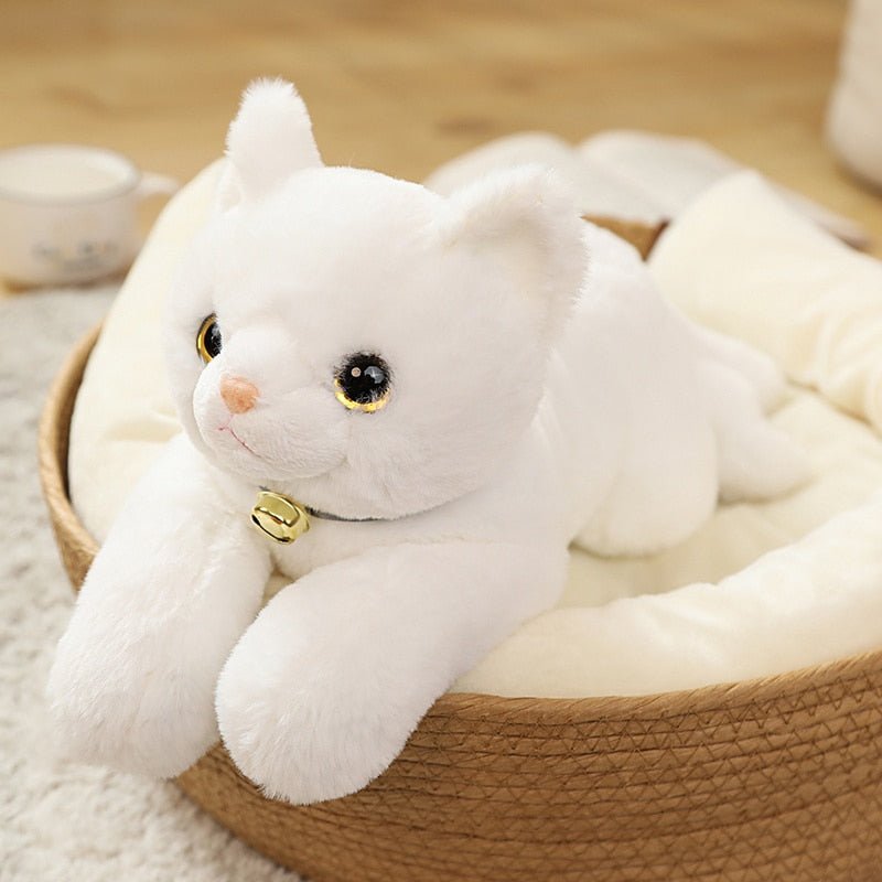 a stuffed white cat that looks real