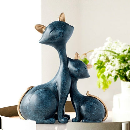 a set of cuddling cat sculptures in blue color for home decor
