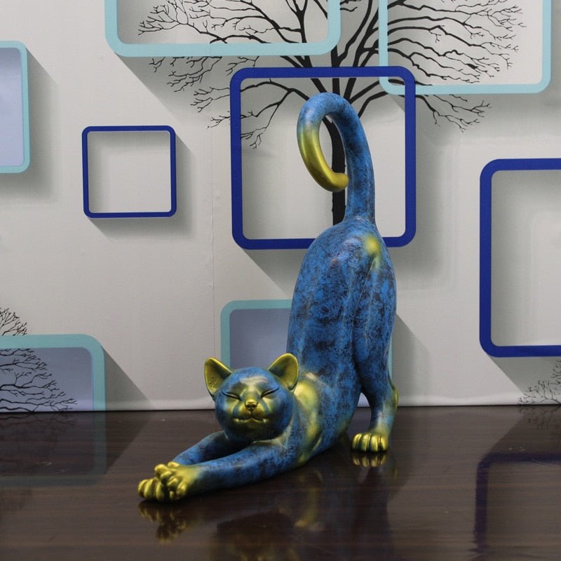 a stretching cat garden statue in blue and gold color