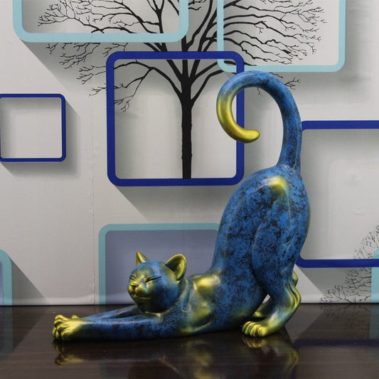 a stretching cat sculpture in blue and gold color