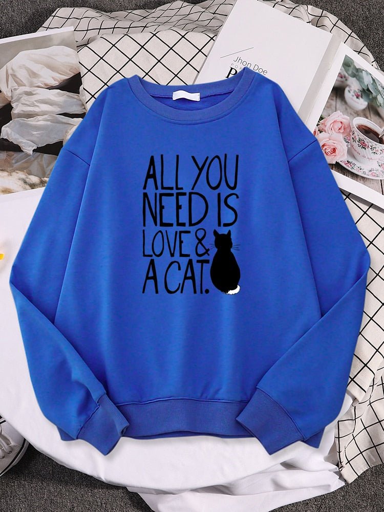a blue color cute cat sweatshirt with the word all you need is love & cat