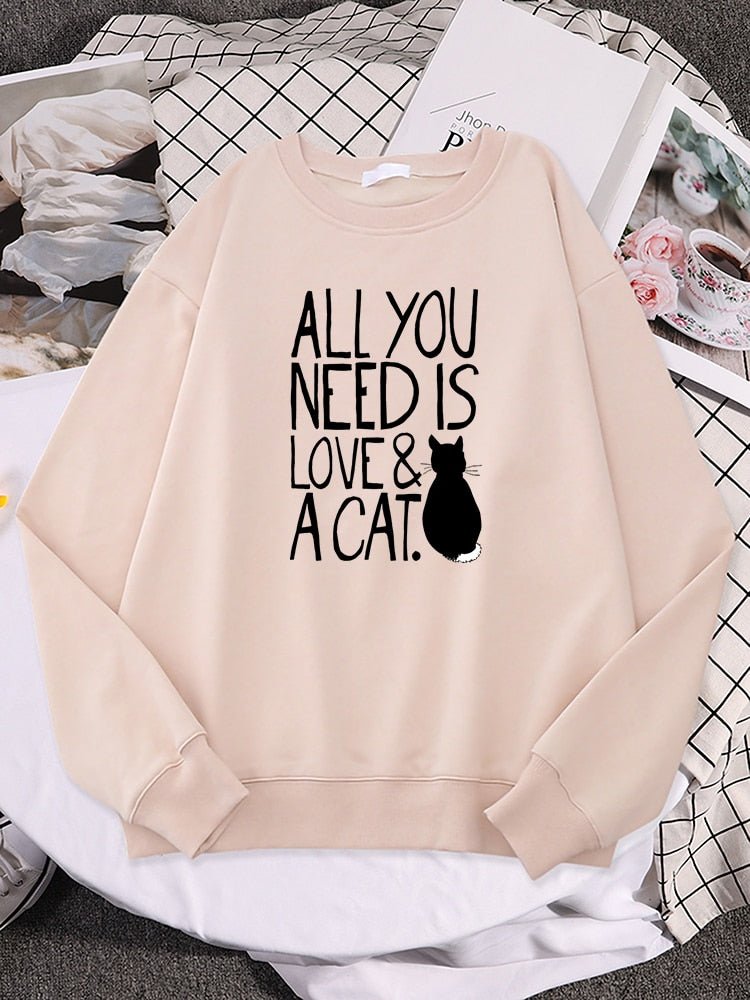 a beige color cute cat sweaters with the word all you need is love & cat