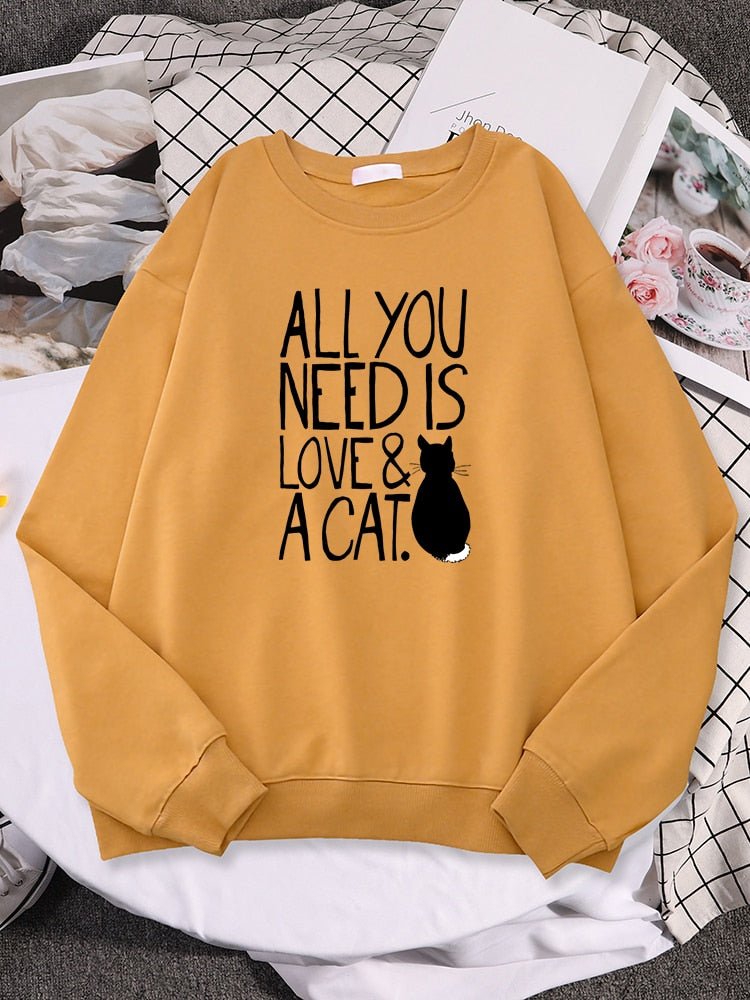 a cat print sweatshirt with the word all you need is love & cat