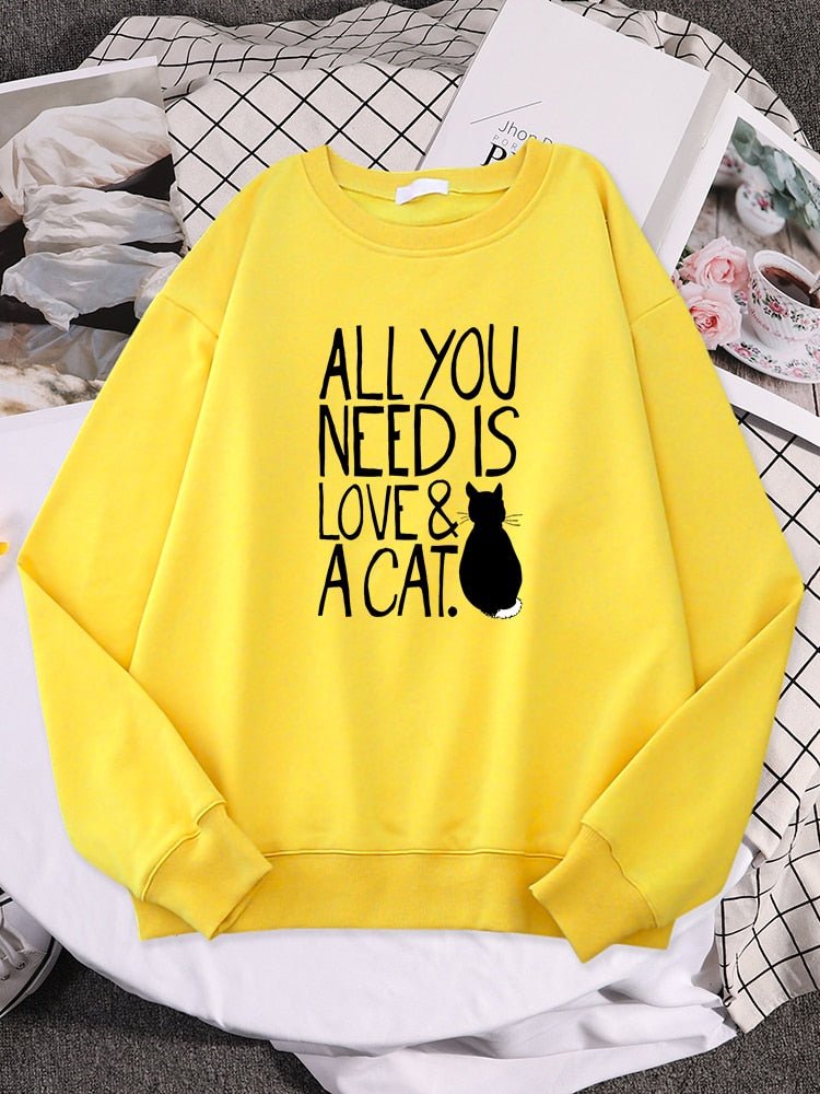 a yellow cat lover sweatshirt with the word all you need is love & cat