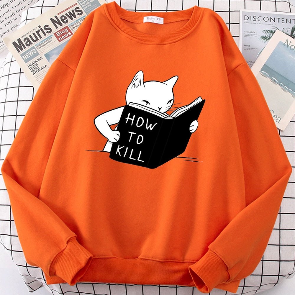 an orange color cat print sweater with a cartoon of a cat learning how to kill