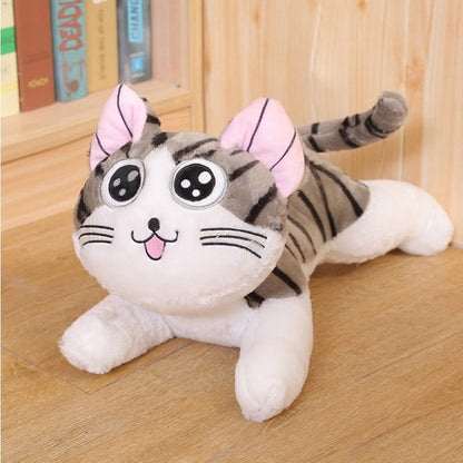 a plushie cat of a tabby cat smiling
