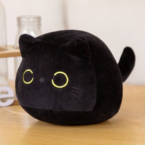a plushie cat of a black cat with yellow eyes