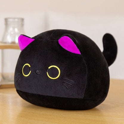 a kawaii cat plushie of a black cat with yellow eyes