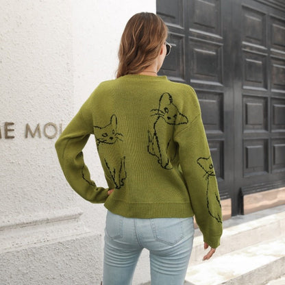 a woman wearing a green cute cat sweatshirt with cute design