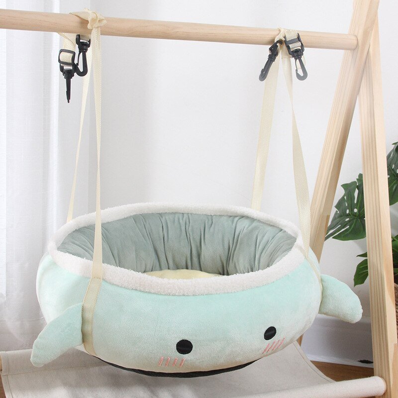 turquoise color cat bed that can swing on a wooden platform