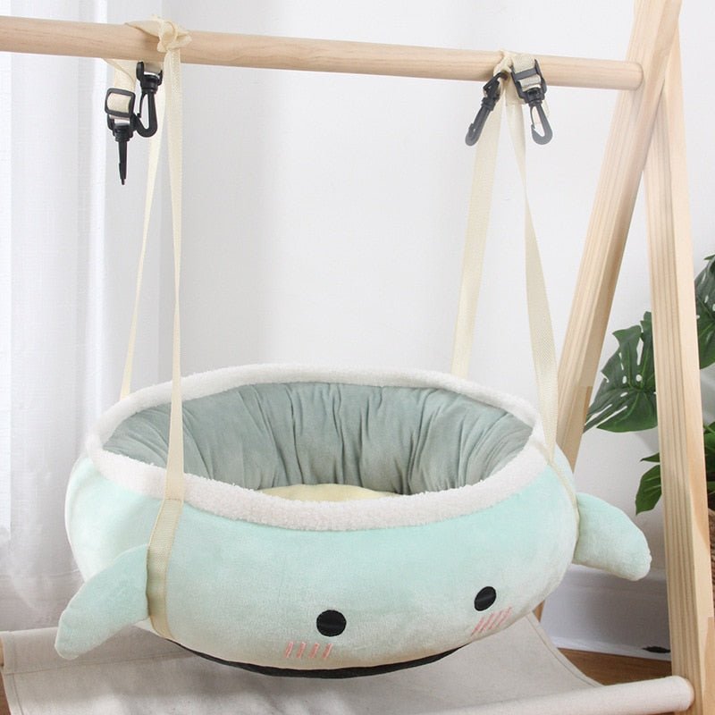hammock style cat bed in soft turquoise color with a cute cartoon design