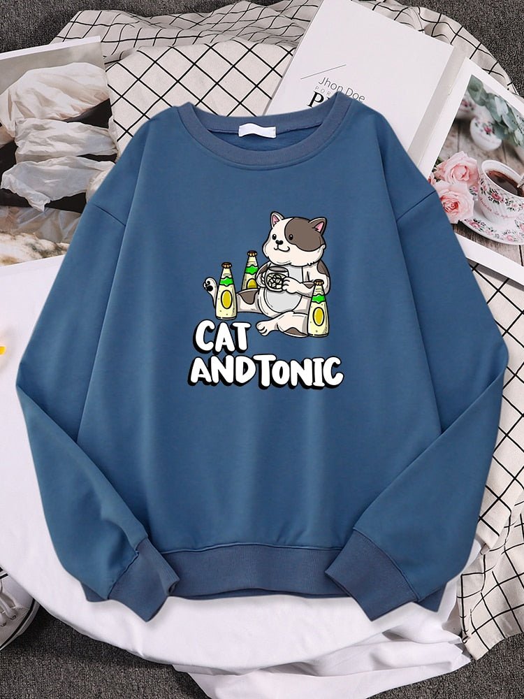 a blue color cat print sweatshirt with picture of a cat drinking tonic drinks