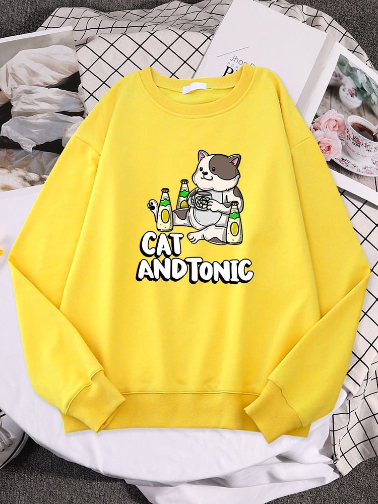 a yellow color cute cat sweaters  with picture of a cat drinking tonic drinks