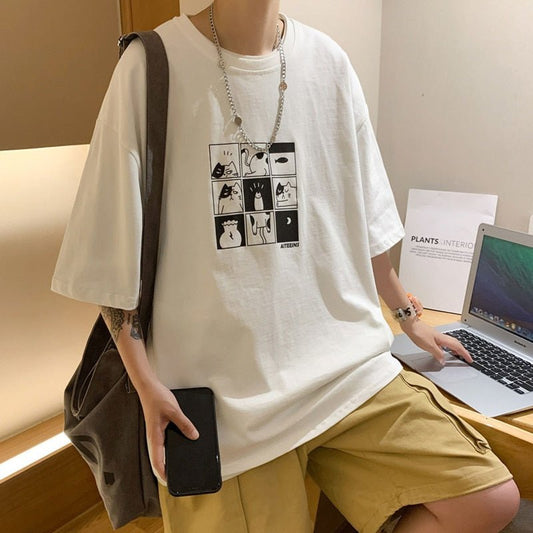 A man wearing a funny black and white oversized shirt with popular cat memes printed across the front