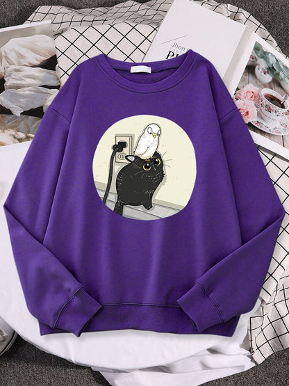 a purple sweatshirt with cat featuring a white pigeon chilling on a black cat