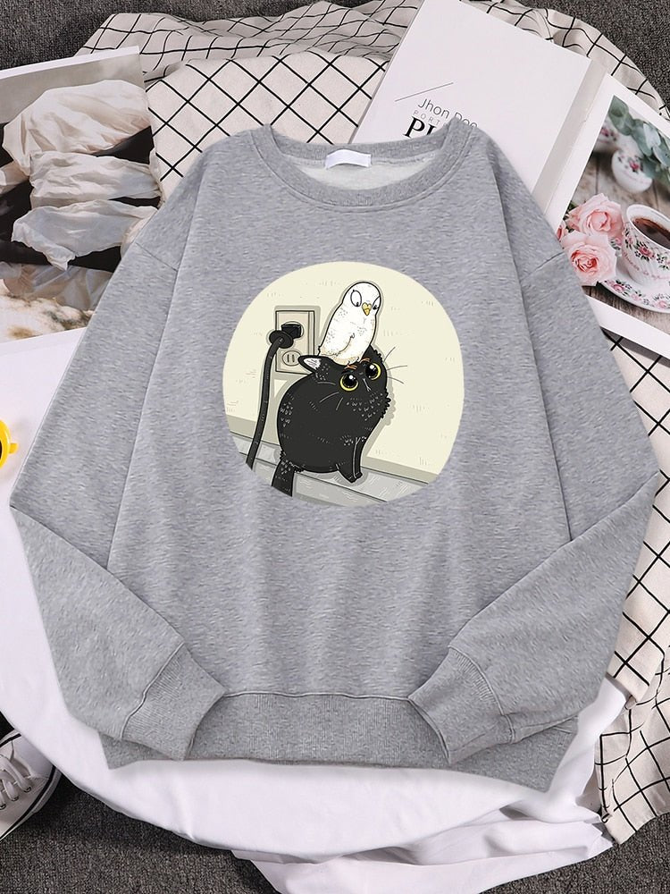 a grey cat pattern sweater with a picture of a pigeon chilling on a cat