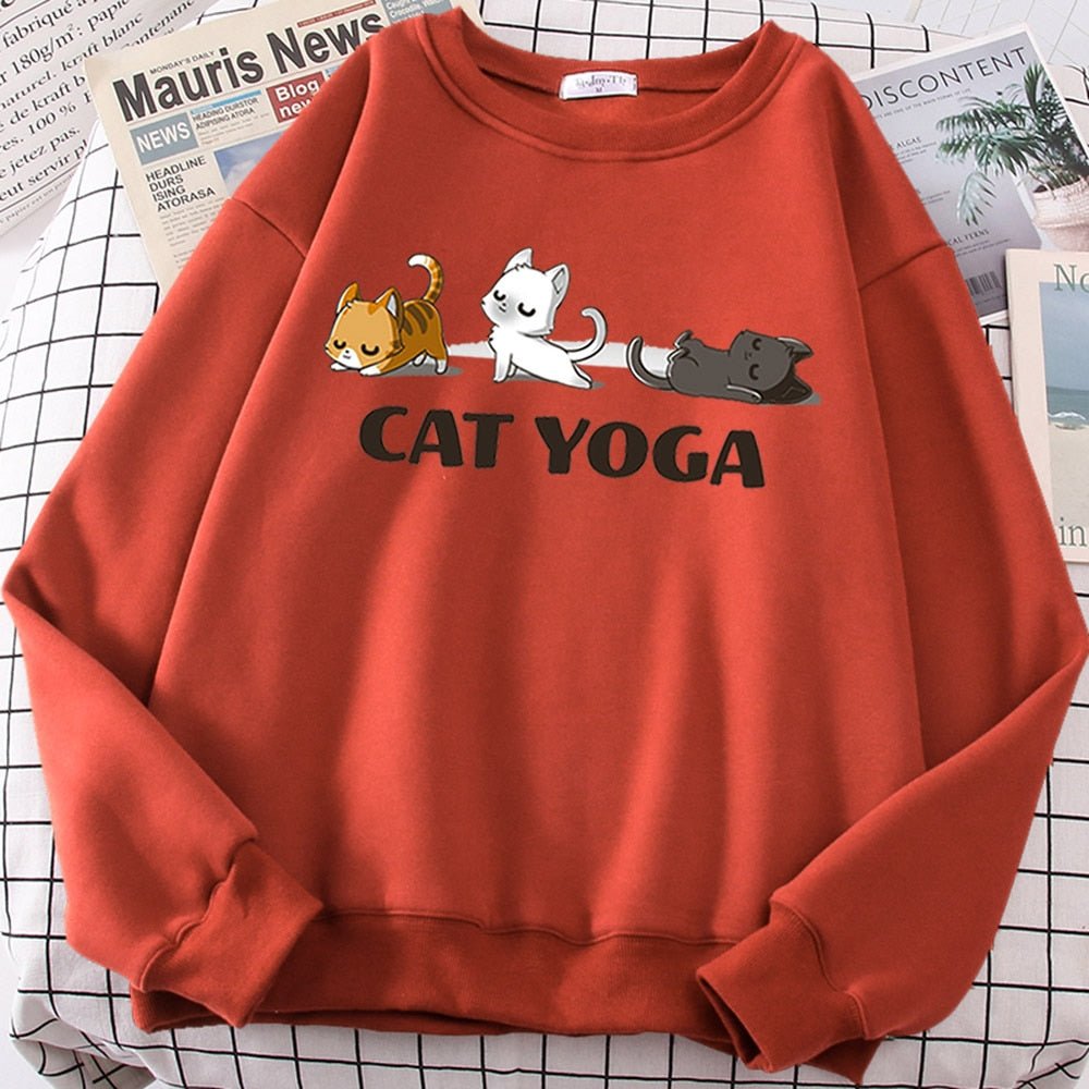 an orange color cat pattern sweater with picture of cats doing yoga