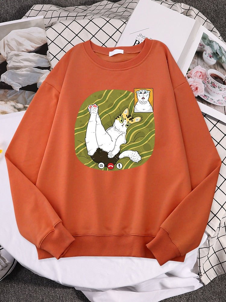 a cat themed sweatshirt featuring two cats having a facetime