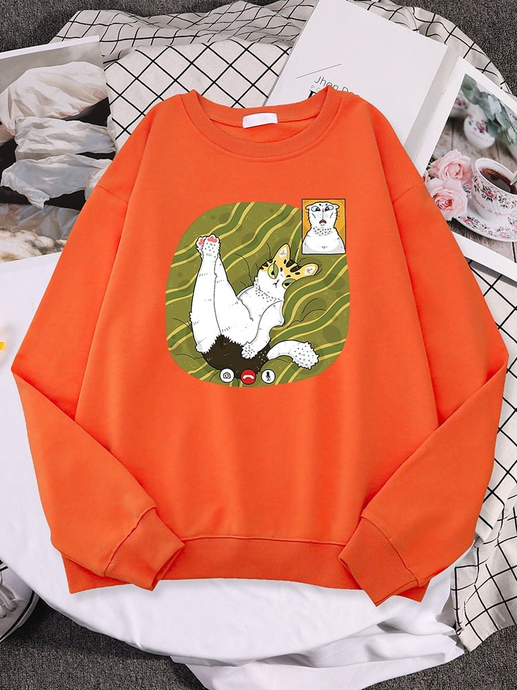 an orange sweatshirts with cats on them featuring two cats having a facetime call