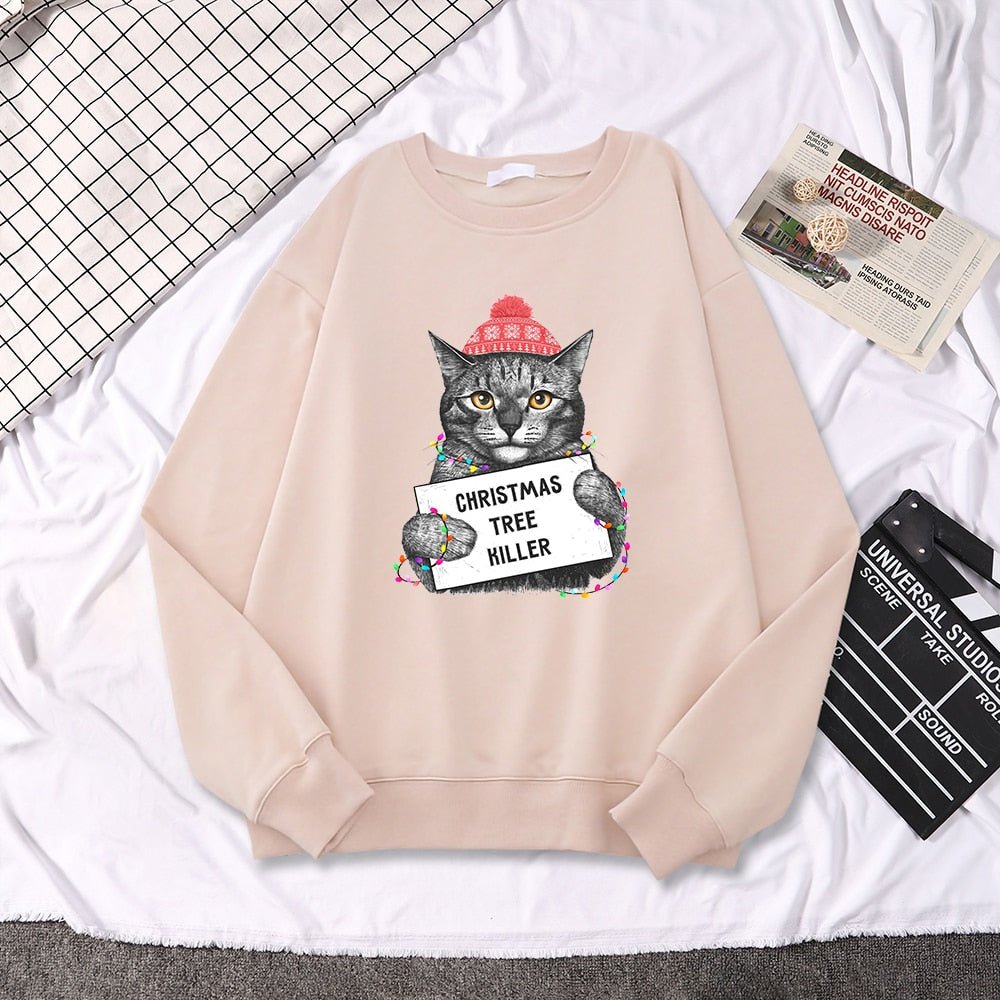 beige color hoodie with hilarious message featuring a cat holding a signage of Chirstmas tree killer
