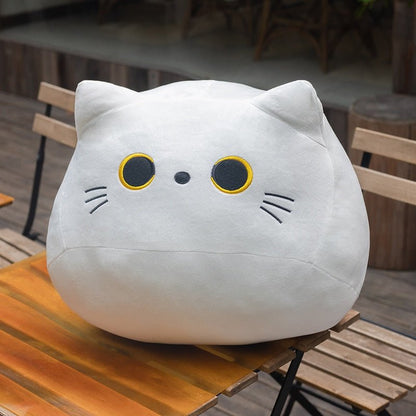 a grey cat plush on a table