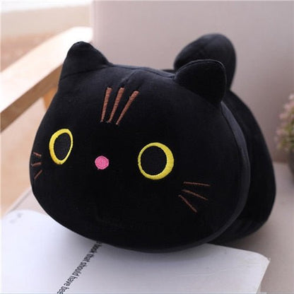 a black cat plushie with yellow eyes
