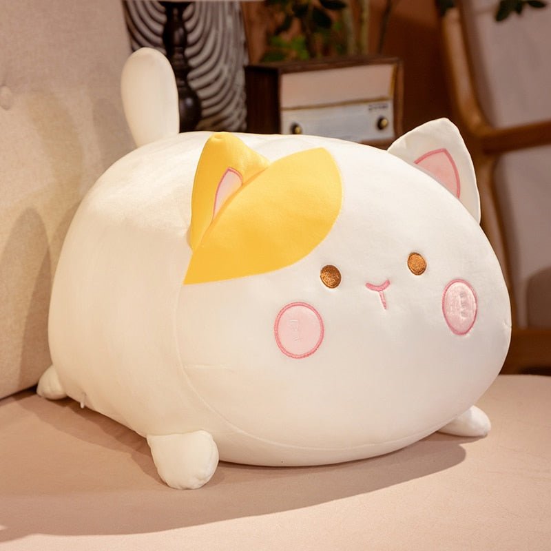 a white cat stuffed animal with fat body
