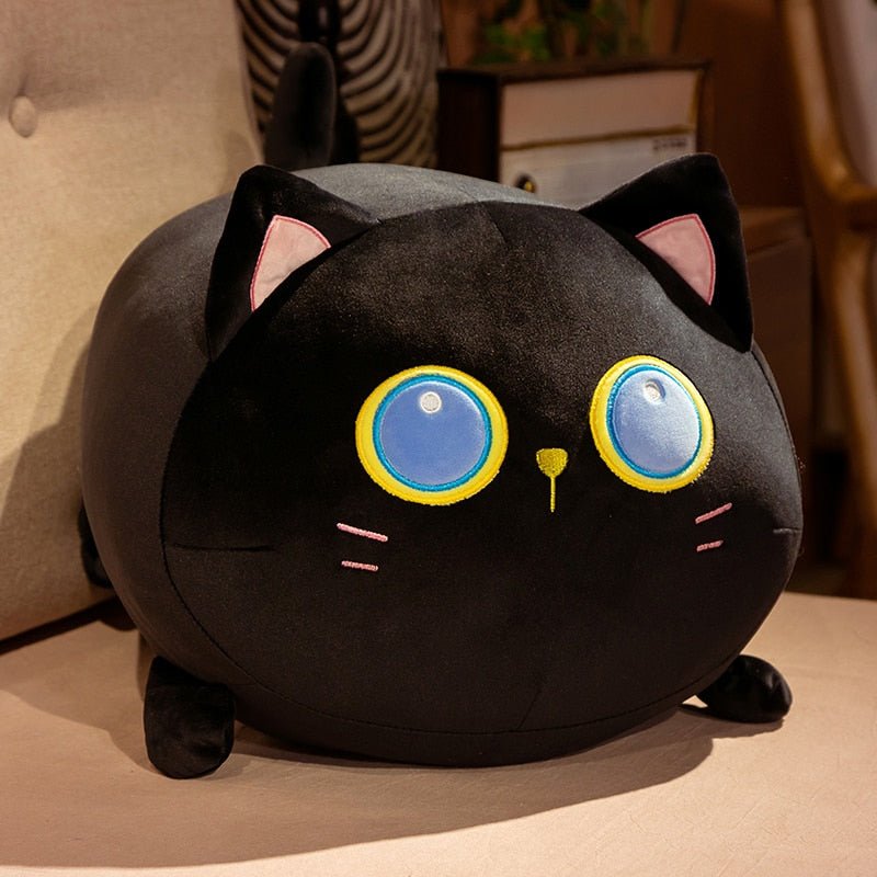 a black cat plush with big eyes