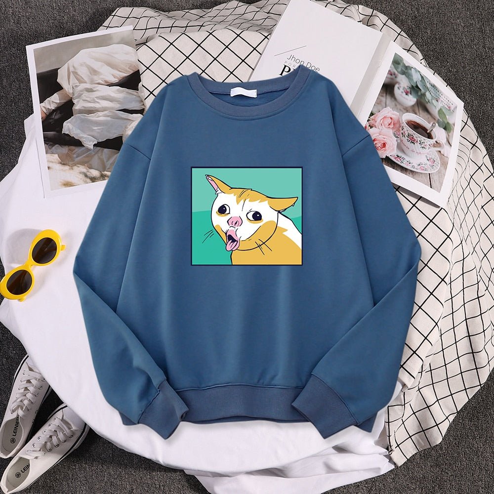 a haze blue color sweatshirt printed with a coughing cat meme on it and looks extremely hilarious
