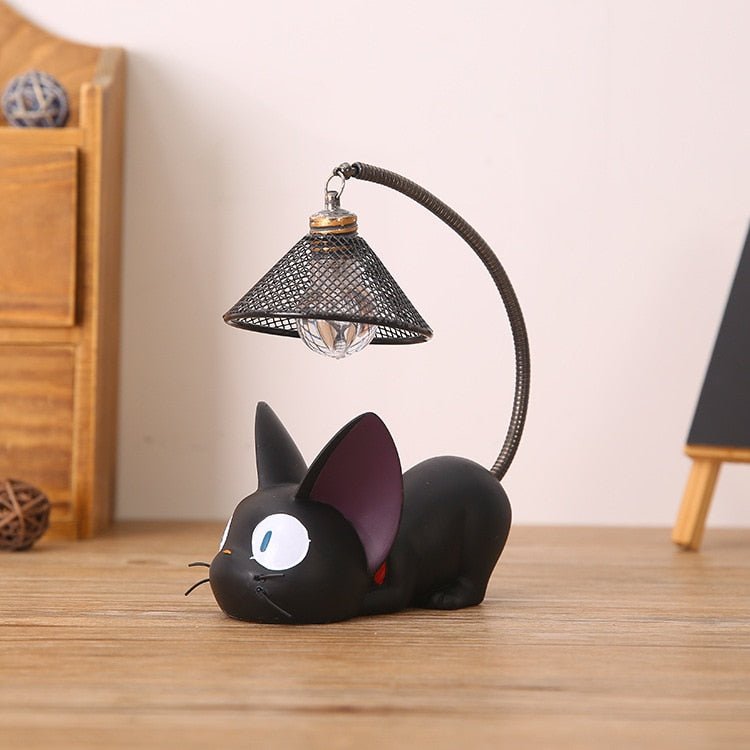 a cute cat sculptures table lamp featuring a black cat sitting on a table
