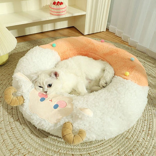 cat sleeping in a cat bed that is shaped like a donut with hoat design on it that looks cute